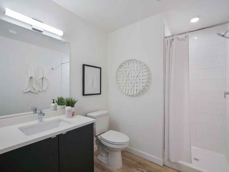 Bathroom with quartz vanity and walk-in shower