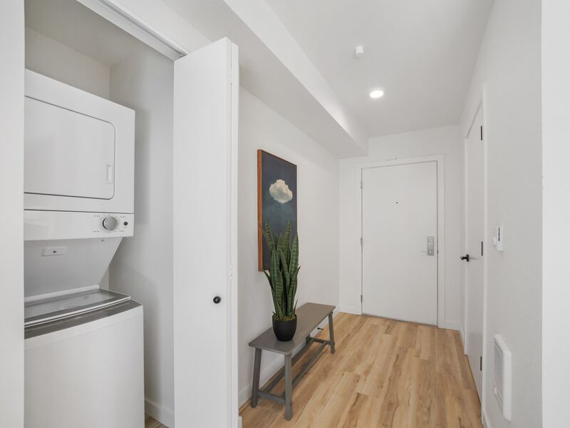 Entry hall with stacked washer and dryer